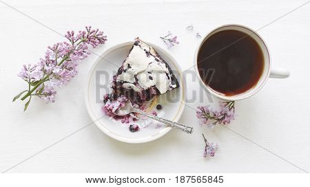 Tender homemade baking blueberry pie with lilac and tea