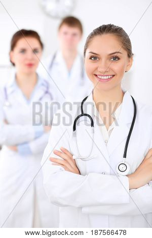 Happy doctor woman with medical staff at the hospital.