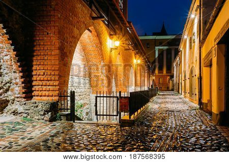 Riga, Latvia. Part Of Old The City Wall In Torna Street In Lighting At Evening Or Night Illumination In Old Town. Blue Hour
