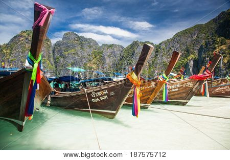 KO PHI PHI LEH, THAILAND, February 1, 2014: Traditional long tail boats on the beach of Maya Bay, Andaman Sea, famous tourist destination in the Ko Phi Phi achipelago