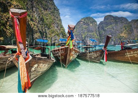 KO PHI PHI LEH, THAILAND, February 1, 2014: Traditional long tail boats on the beach of Maya Bay, Andaman Sea, famous tourist destination in the Ko Phi Phi achipelago