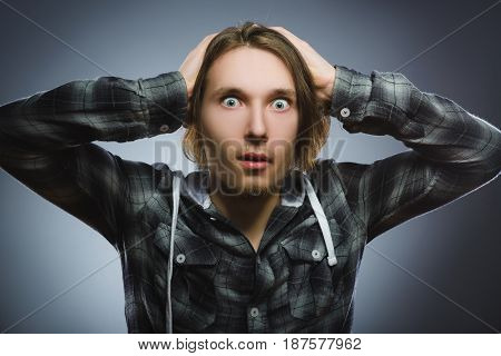 Closeup Scared and shocked little boys. Studio shot portrait over gray background. Human emotion face expression. Life perception achievement vision.