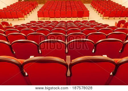 red auditorium chairs empty in theatre wood