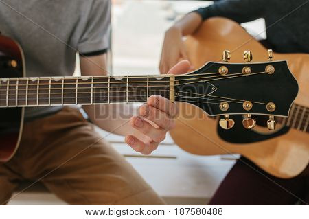 Learning to play the guitar. Music education and extracurricular lessons. Guitarist