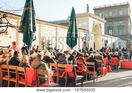 Munich, Germany, December 29, 2016: Popular among the local population and tourists is the open-air restaurant on the Odeonsplatz in Munich. The winter vacation. Daily life in Europe.