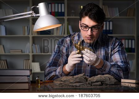 Archeologist working late night in office