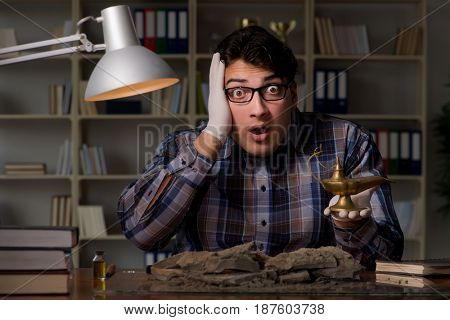 Archeologist working late night in office