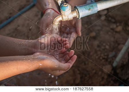 Close up Asian children wash hands .