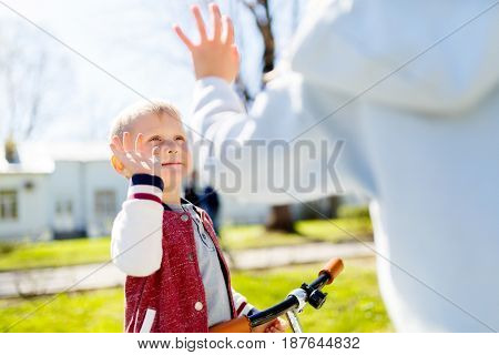Victory blow by hands of girl and boy for walk in park