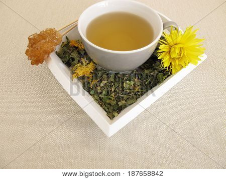 Herbal tea with marigold and cornflower on tray