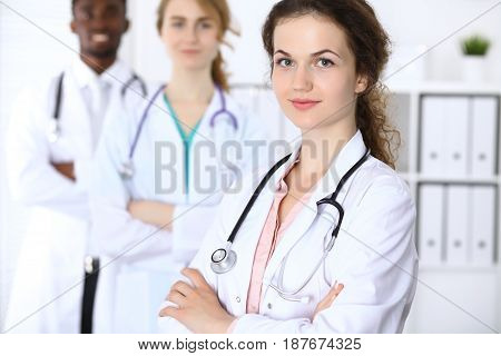 Happy doctor woman with medical staff at the hospital.