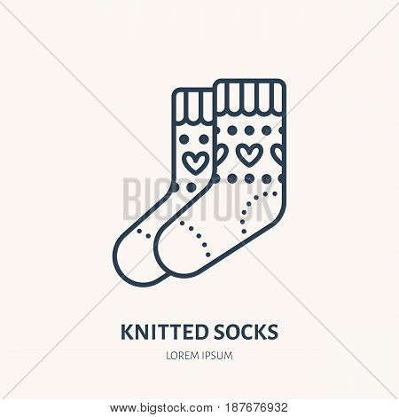Illustration of woolen socks. Knitted clothing shop line logo. Vector flat sign for atelier or garment shop.
