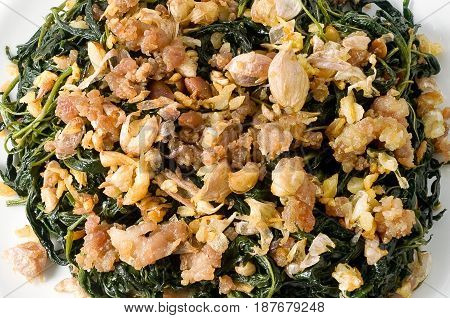 Chinese Traditional Food Close Up of Stir Fried Jute Leaves or Mulukhiyah Leaves with Minced Pork Garlics and Fermented Soy Bean.
