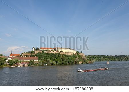 Barge passing in front of Petrovaradin fortress in Novi Sad Serbia. This castle is one of the symbols of Serbia Danube river is the main axis of navigation in Europe