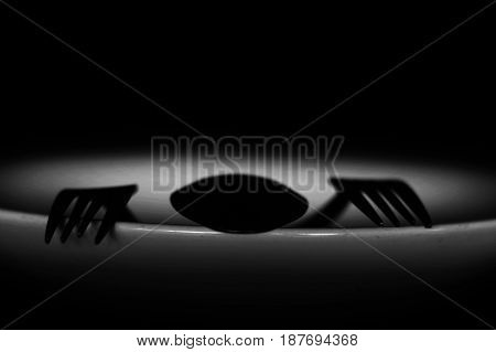 Spoon And Fork On Empty Plate In White Tone, Diet, Poverty Or Afraid Of Eating Concept