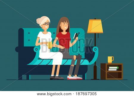 Couple girl with smart phone chatting and sitting in cozy armchair with a cup of hot tea or coffee. Friends relationship.