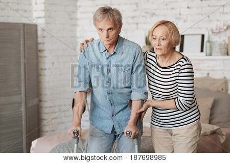 I got your back. Productive motivated aged gentleman wanting taking a walk and using the crutches for this while his wife supporting him