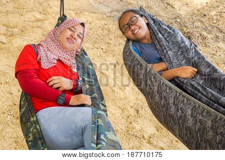 Labuan,Malaysia-Feb 19,2017:Young people relaxing & enjoying the hammock on tropical beach in Papan island,Labuan,Malaysia.