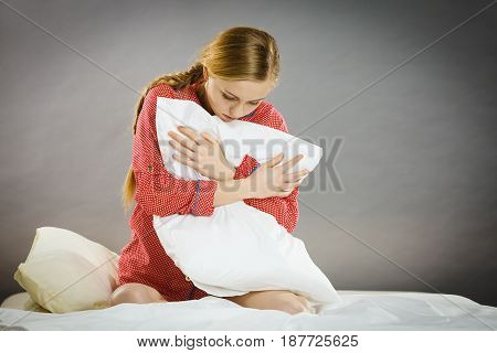Sad Depressed Girl In Bed Gripping Pillow