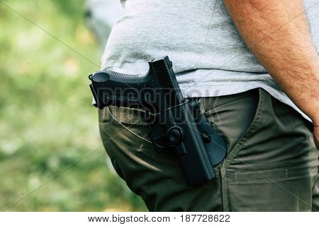 Pistol in the holster. The shooter trains. Is preparing to shoot at the target.