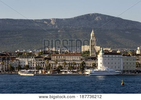 Split view on south part of old town behind sea and boats are Diocletian's palace and St Domnius cathedral