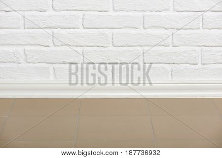 white brick wall with tiled floor closeup photo, abstract background photo