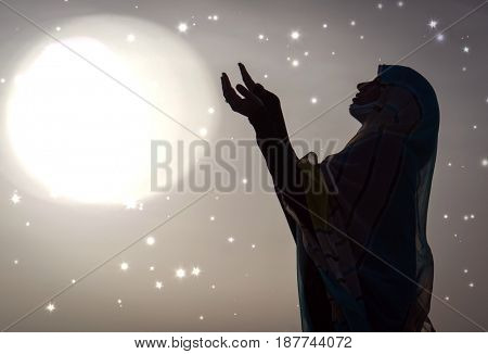  Copy space of silhouette woman rising hands on sunset sky double exposure colorful bokeh and bird fly background. Vintage tone filter effect color style.