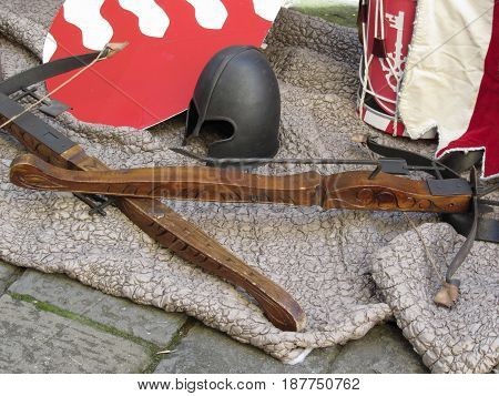 Replicas of medieval helmets crossbows shields and musical instruments . Photo taken during outdoor public event (no ticket required) in public place . Pistoia Italy