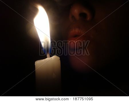 blowing candles in the dark room that Blackout day or birthday. photo.