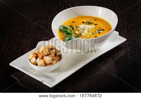 Pumpkin and soup with cream and pumpkin seeds