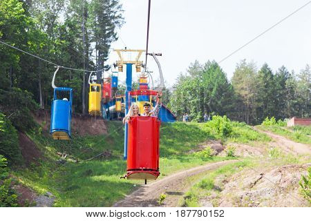 young loving happy couple in cable car ropeway.