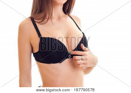 beautiful big natural breasts in a black bra close-up isolated on white background