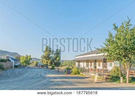 NIEU BETHESDA SOUTH AFRICA - MARCH 22 2017: Early morning street scene with a restaurant to the right and the Owl House to the left in Nieu-Bethesda an historic village in the Eastern Cape Province