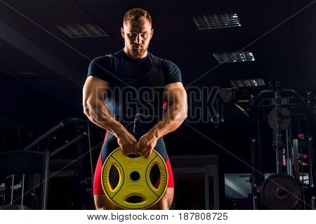 Huge Weightlifter Stands With A Weight In His Hands
