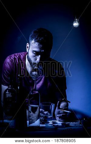 Young Man With Beard Lost In The Vices Of Alcoholism Smoking And Drug Addiction