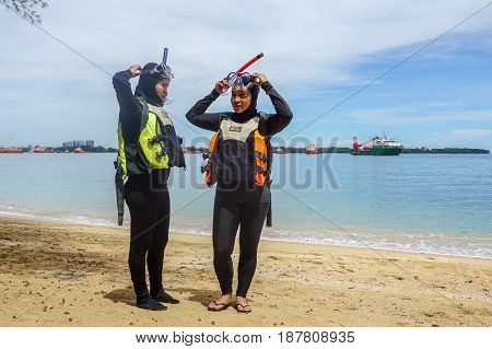 Labuan,Malaysia-Feb 19,2017:Young woman with life jacket & snorkel gear,ready to having fun doing snorkel watersport activity in Papan island of Labuan,Malaysia.
