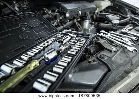 Car Mechanic Man At The Garage Fixing The Engine