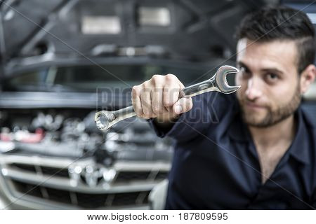 Car Mechanic Man At The Garage Fixing The Engine