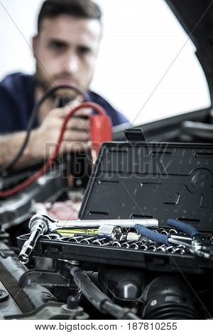 Car Mechanic Man At The Garage Fixing The Engine