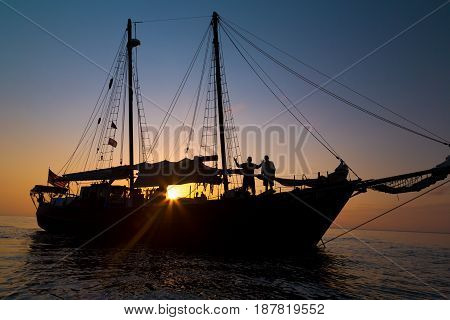 Gaff rigged schooner silhouette in the setting sun