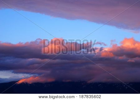 Sunset reflecting on clouds above the Swan Mountain Range near Kalispell, Montana