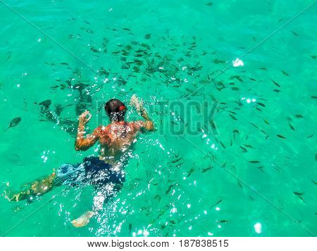 Tourist snorkeling in Andaman sea at Ko Kradan Island, Thailand. The blurred view