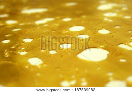 Close-up shot of highly pure and concentrated slab of shatter wax.