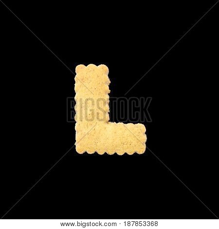 Closeup brown biscuit in L english alphabet isolated on black background with clipping path