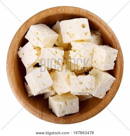 Wooden bowl of diced soft cheese isolated on white background Top view
