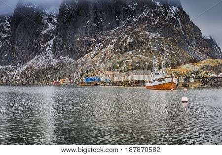 Beautiful Picturesque Harbour Seascape Against Snowy Mountains at Fishing Village at Lofoten in Norway.Horizontal Image
