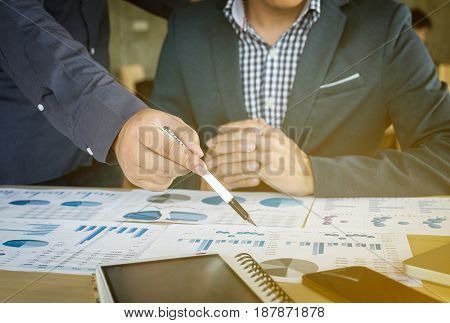 business Teamwork looking at report and having a discussion in office.