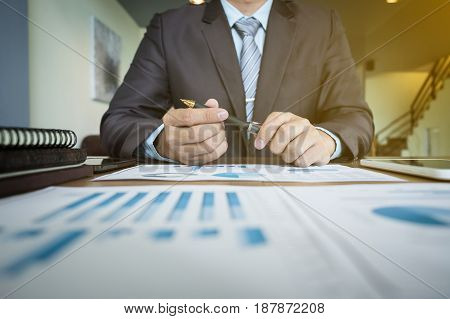 businessman working plan the business and analysis many chart graph.