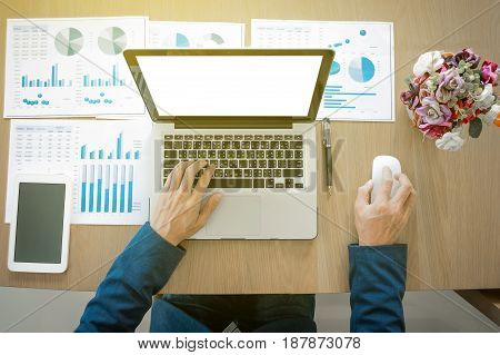 Businessman working at office desk and using a digital tablet computer laptop and many documen new project plan of business.