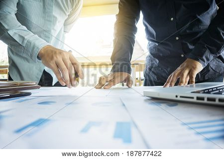 Two businessmen looking at report and having a discussion in office. business concept.
